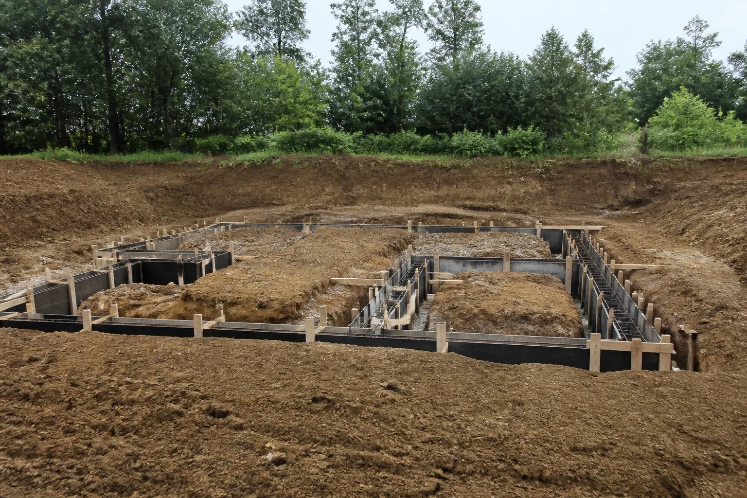 Before: excavated site ready for concrete masonry foundation